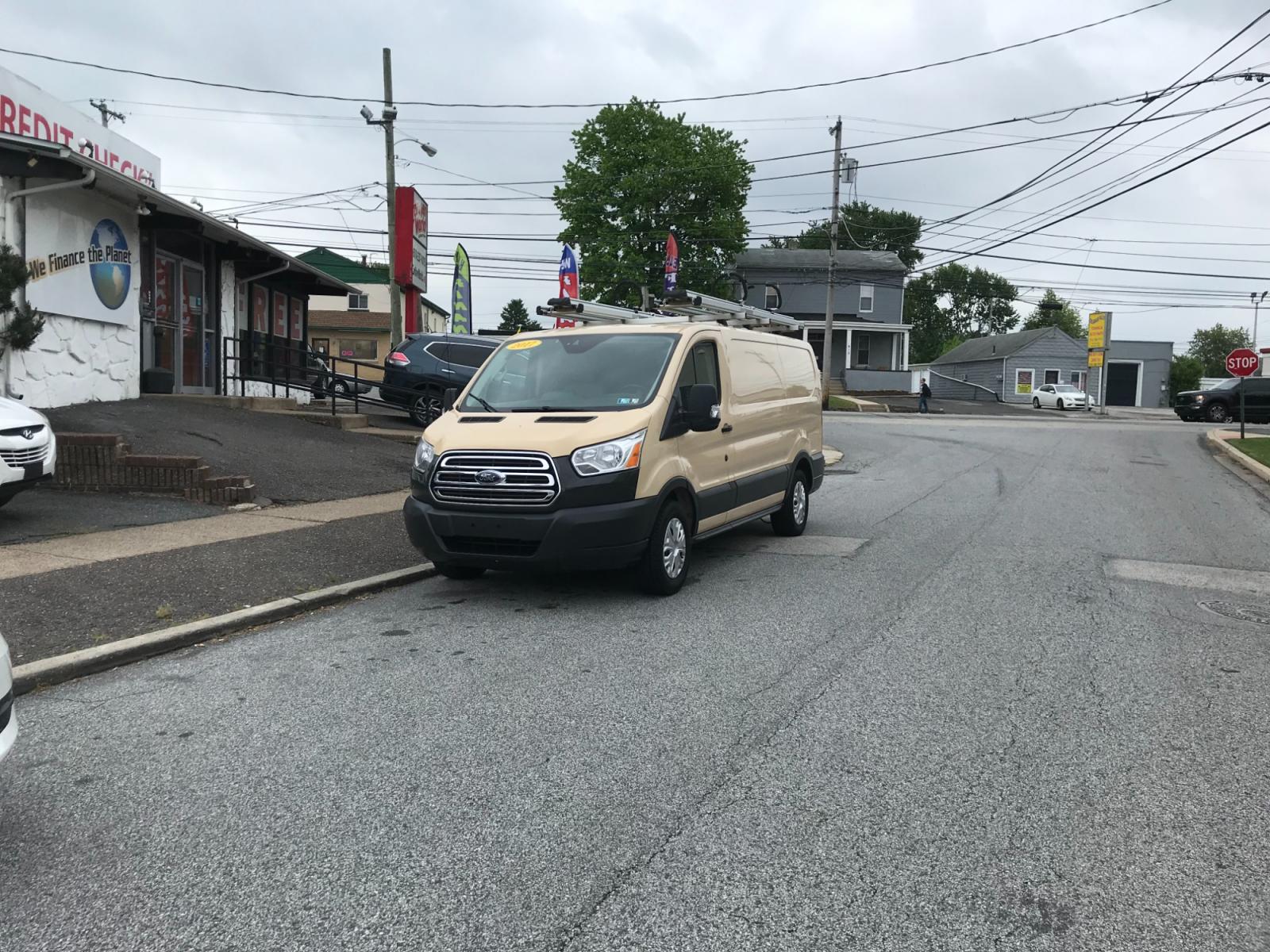 2017 Tan /Gray Ford Transit 150 (1FTYE1YM0HK) with an 3.7 V6 engine, Automatic transmission, located at 577 Chester Pike, Prospect Park, PA, 19076, (610) 237-1015, 39.886154, -75.302338 - 2017 Ford Transit 150: Ladder racks, multiple pieces of shelving, backup camera, partition, power locks and windows, FLEET MAINTAINED, runs LIKE NEW! This vehicle comes inspected and has been given a bumper to bumper safety check. It is very clean, reliable, and well maintained. We offer a unique - Photo #1